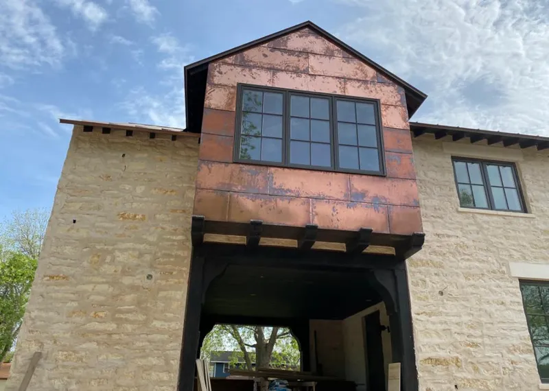 Copper metal panel facade on a stone building for Skylight Installation in Weldon Spring